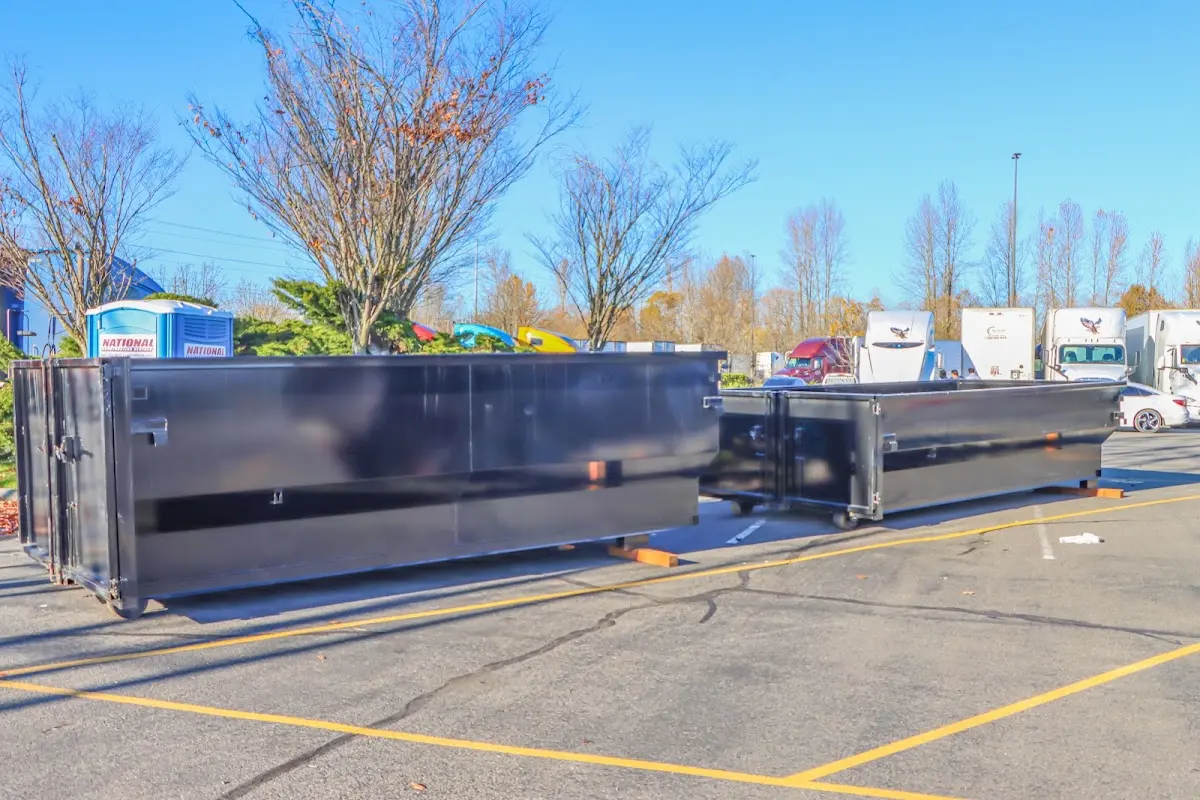 Professional dumpster rental service with roll-off container on residential driveway in Barberton